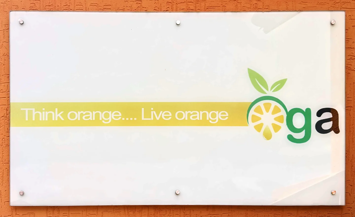 The sign at OGA’s head office: Think orange… Live orange, with OGA’s logo.