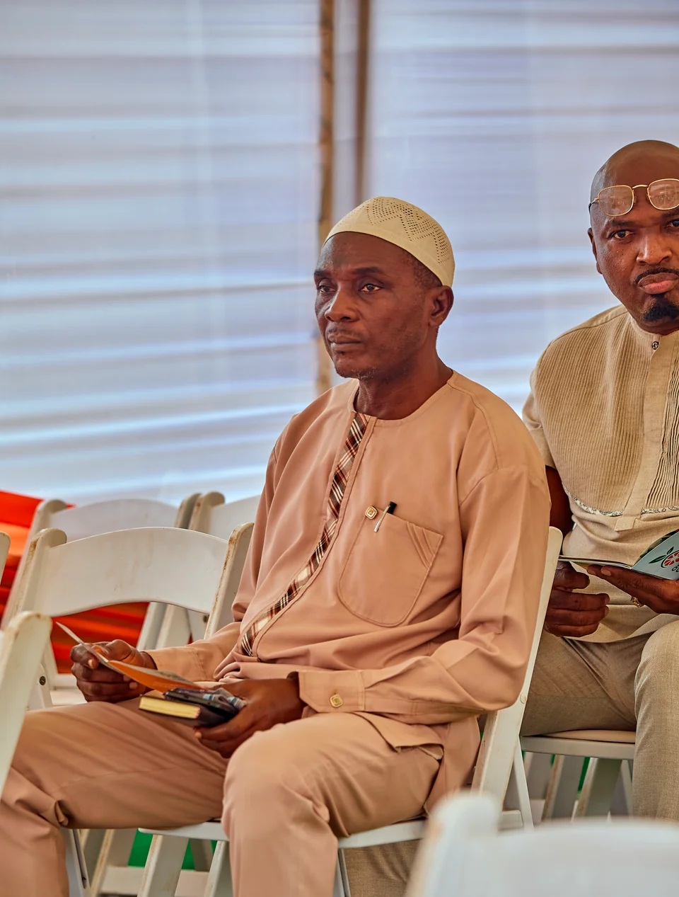Two guests seated at a meeting.