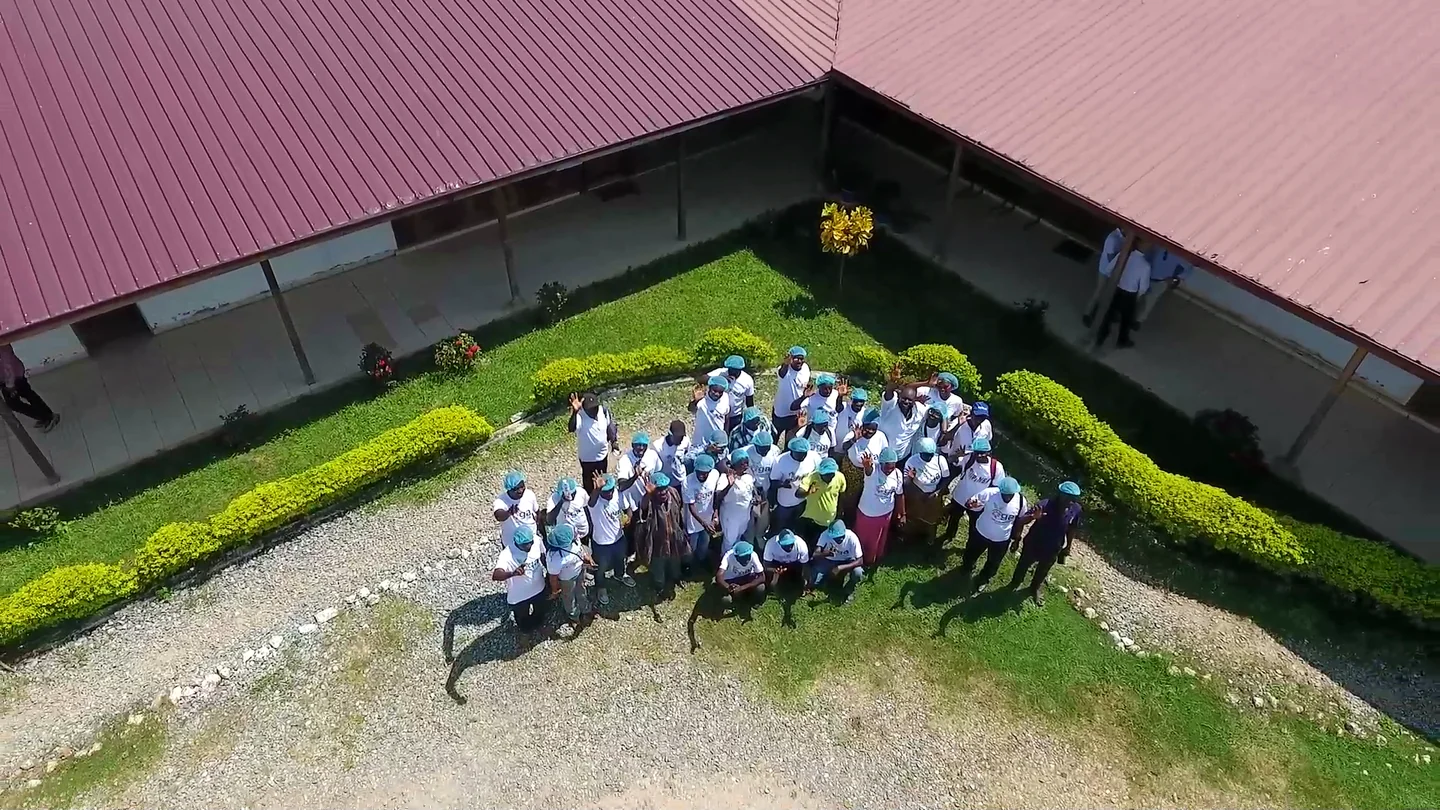 OGA’s members gathered on a lawn, seen from the air.