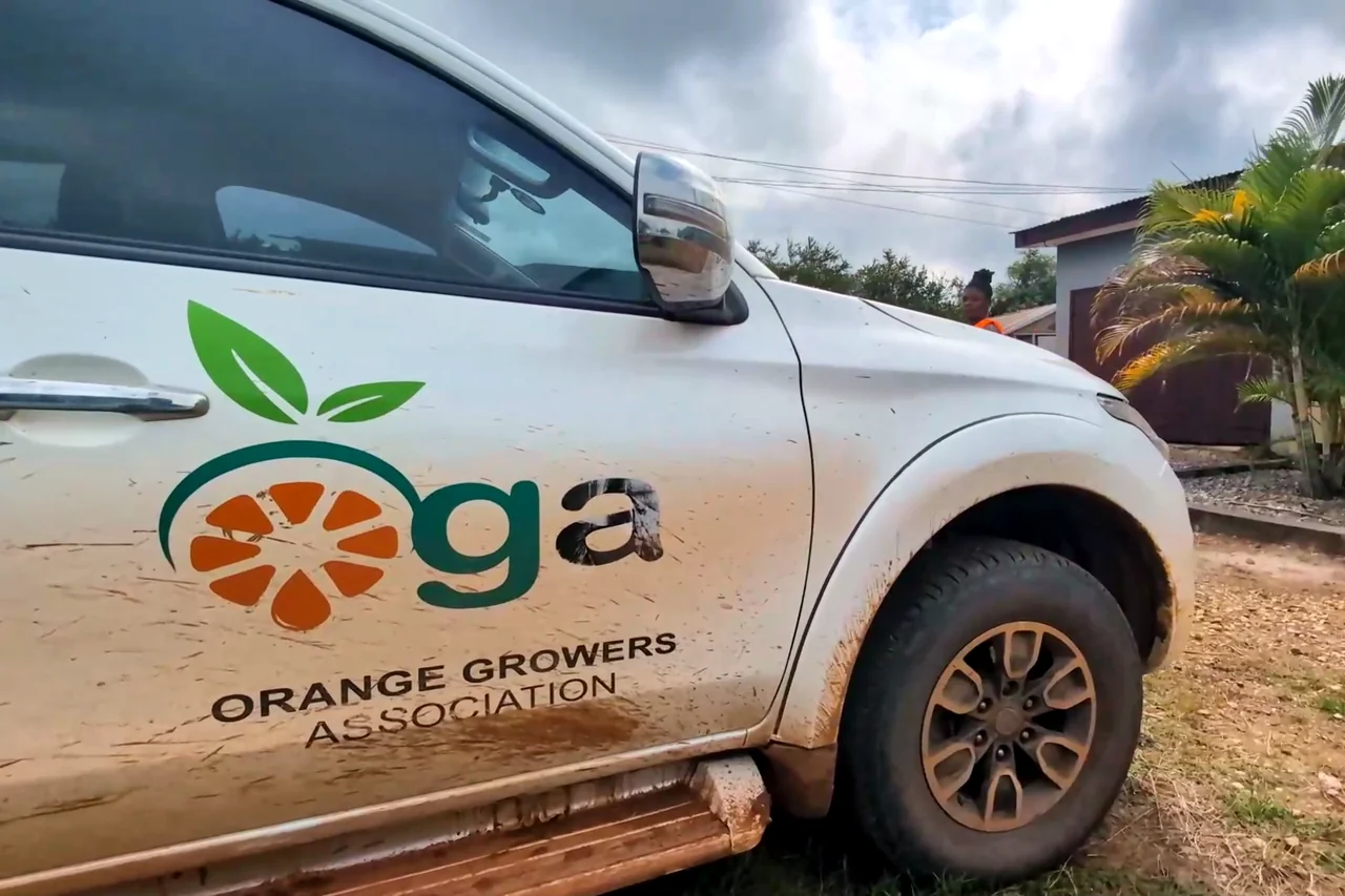 A white pickup with the OGA logo on its door.