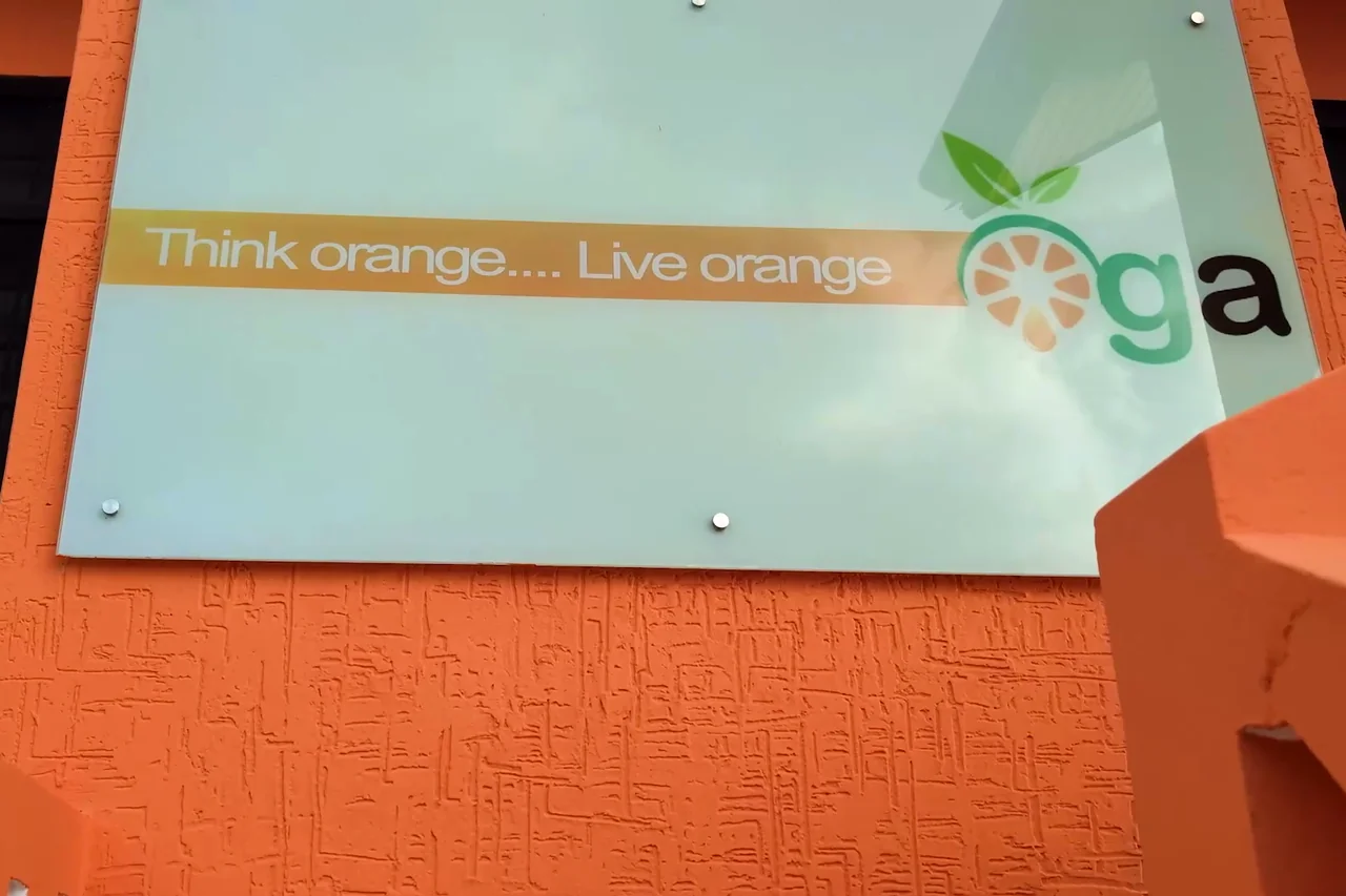 The sign at OGA’s head office reads Think orange, Live orange, beside the OGA logo.